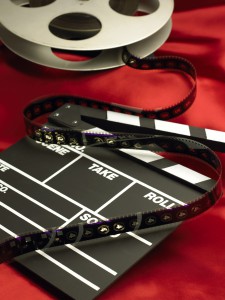 Movie clapboard and film reel